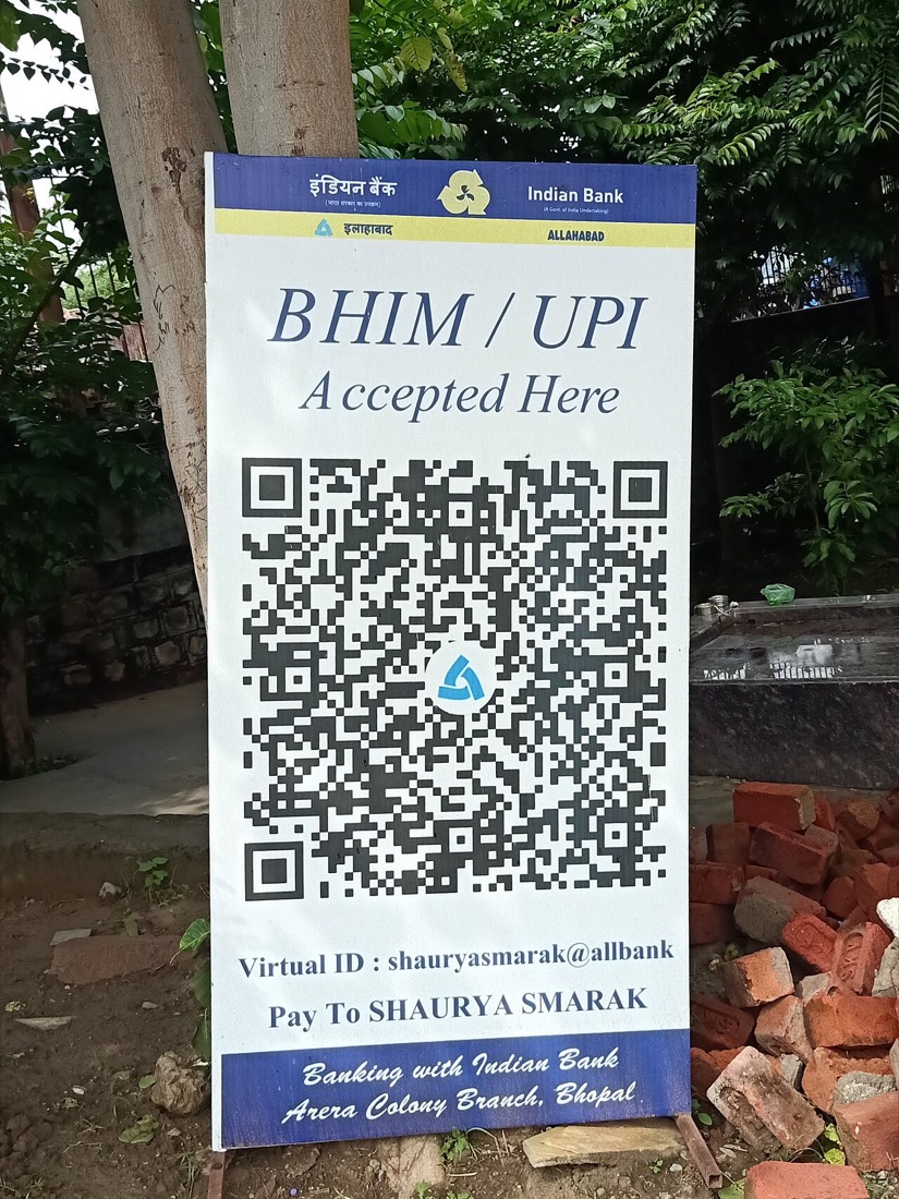 A BHIM UPI QR code accepting payments at a monument ticket counter in Bhopal, the kind of scan-to-pay code behind UPI's 24.51 billion transactions in August 2026