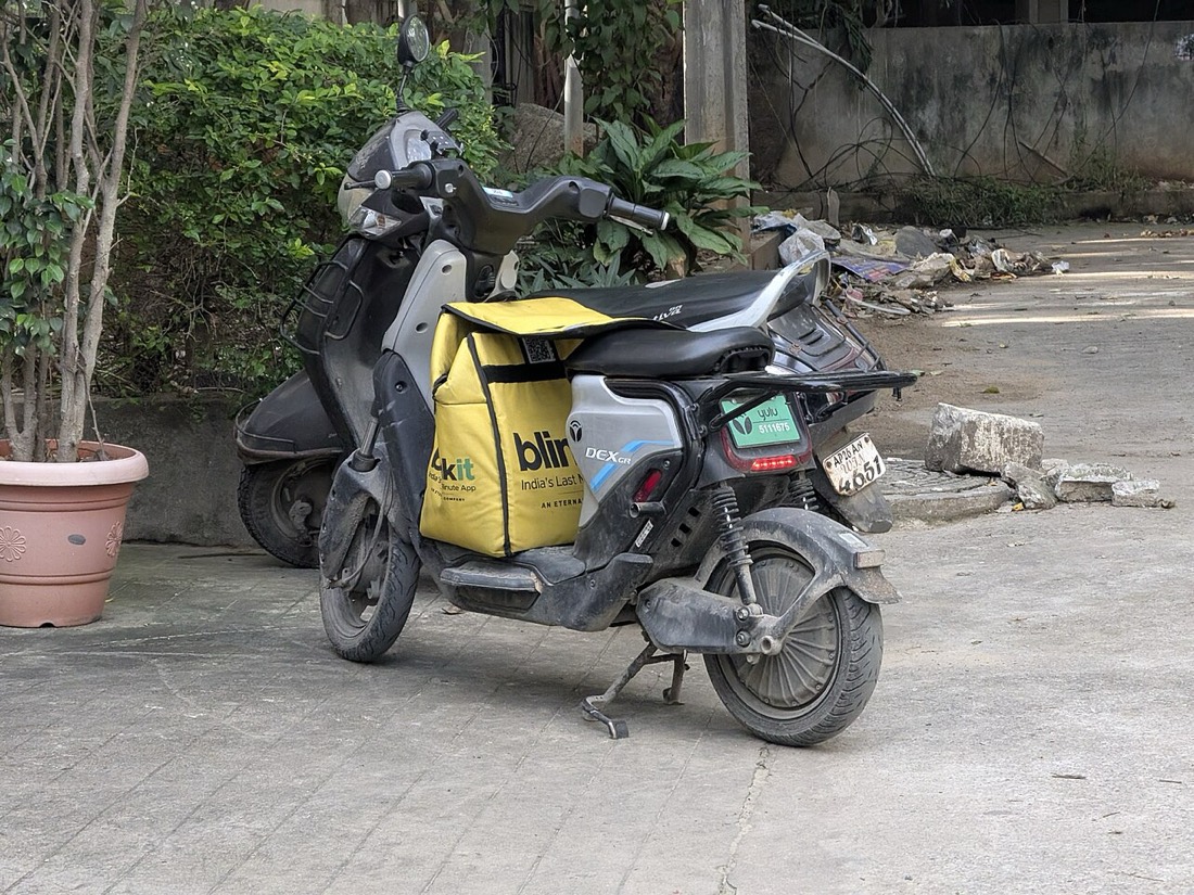 A Blinkit delivery scooter parked in Hyderabad's Hitech City
