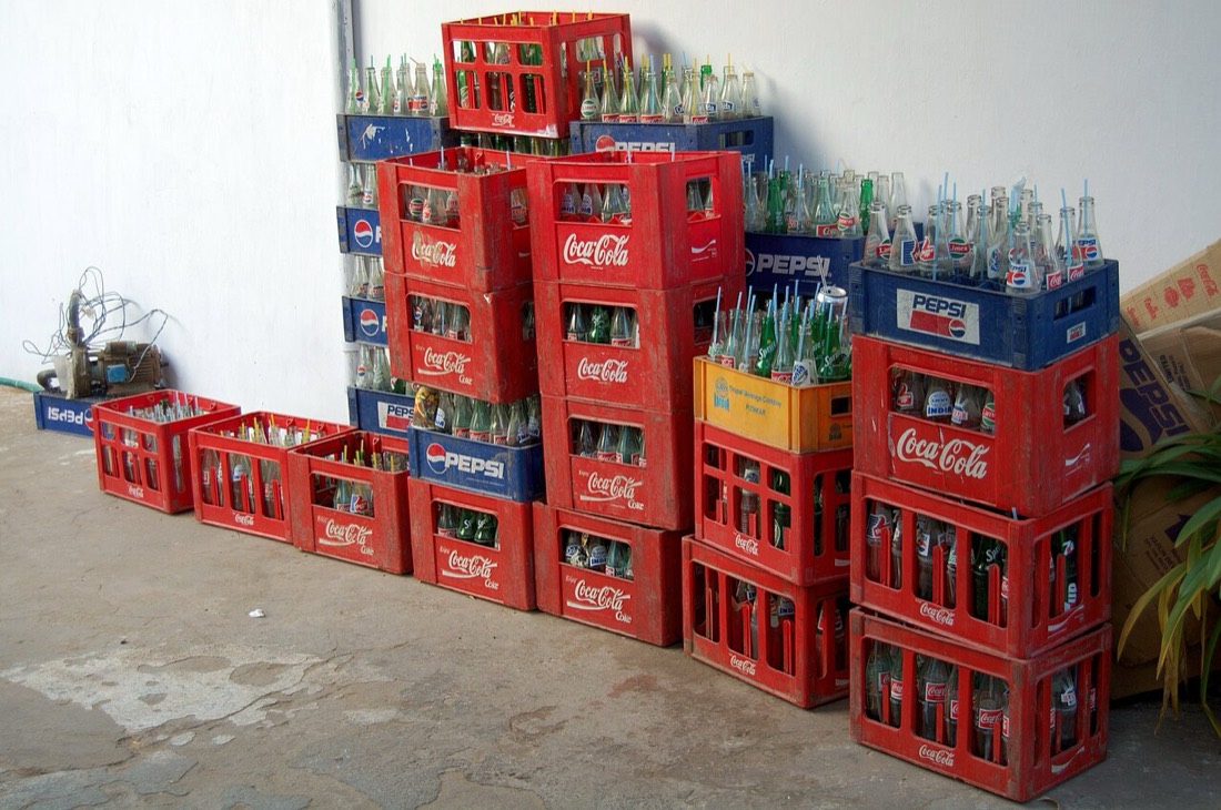 Crates of Coca-Cola bottles stacked outside a shop in India
